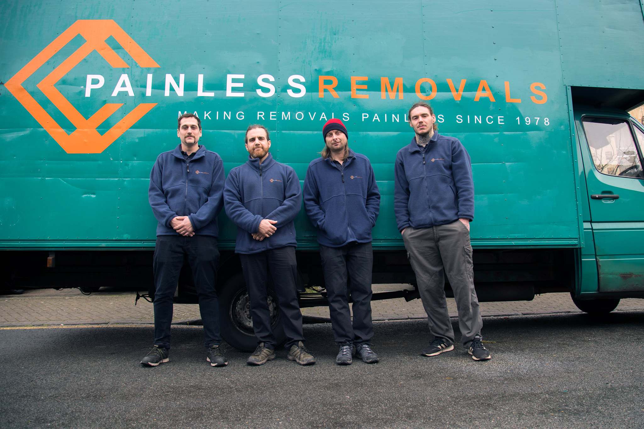 The Painless Removals crew standing together by their van