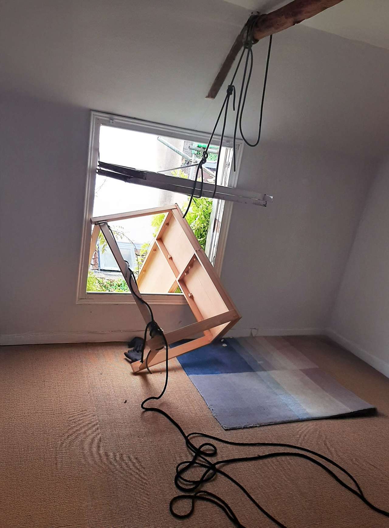 Furniture being carefully lowered through a window using rope systems during a Bristol removal