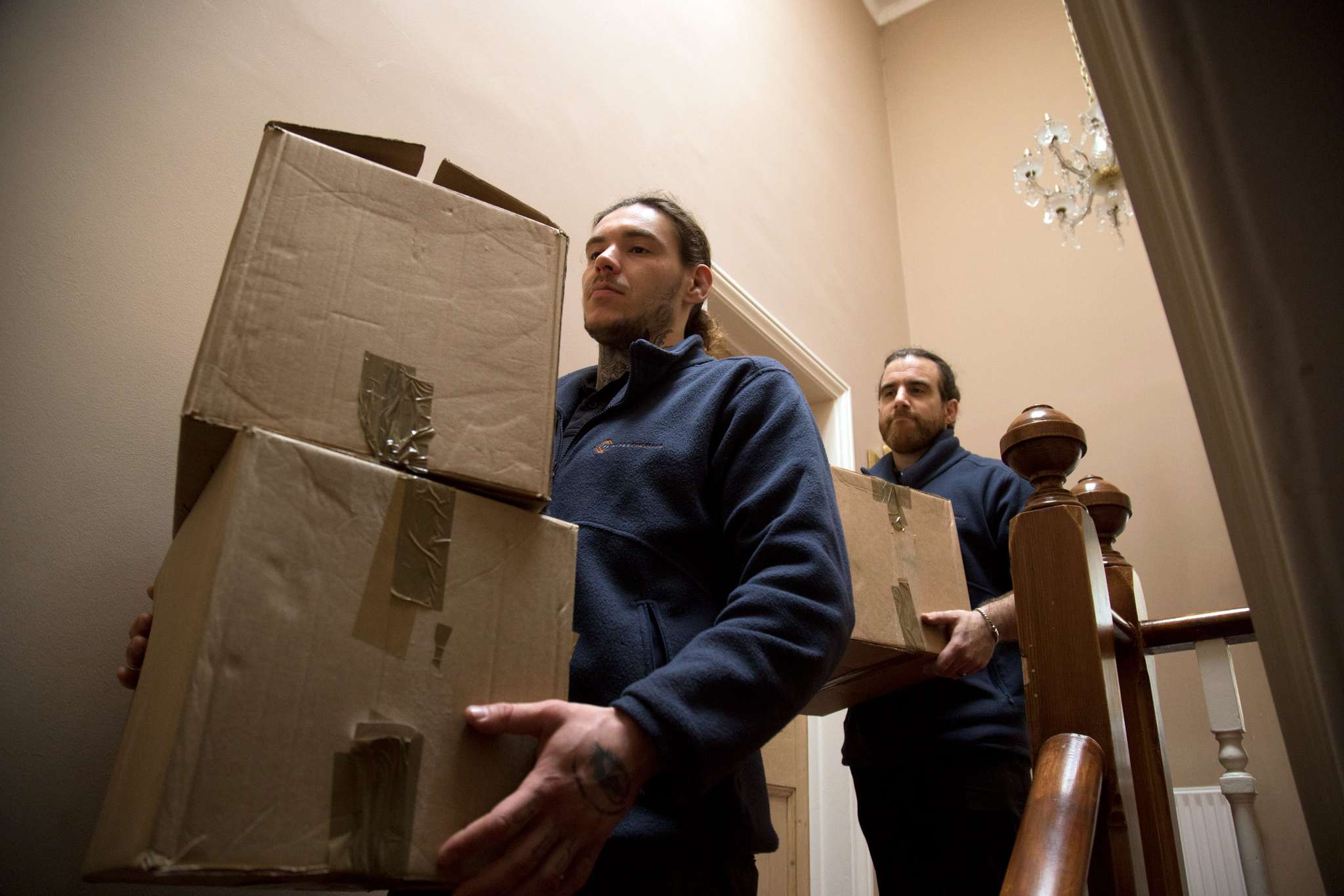 Moving boxes stacked at the bottom of stairs in a Knowle family home ready for the removal crew