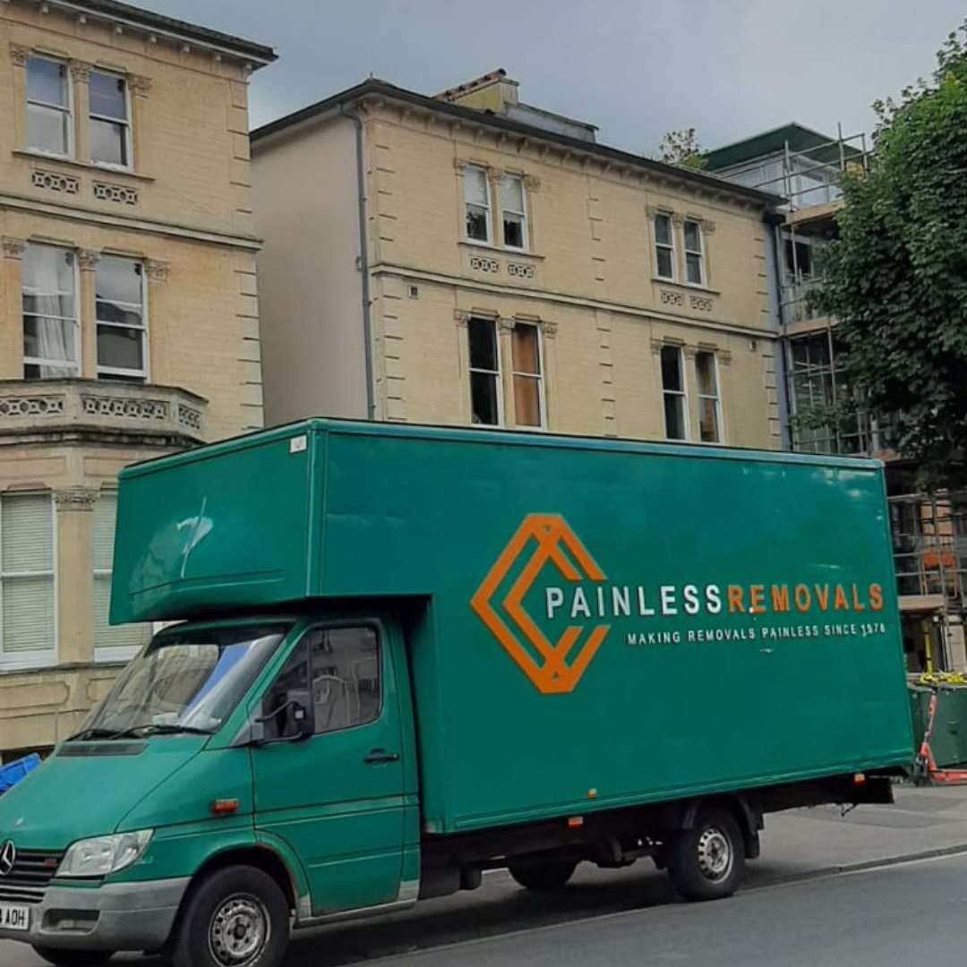 Painless Removals van outside a Victorian villa on a tree-lined Redland street