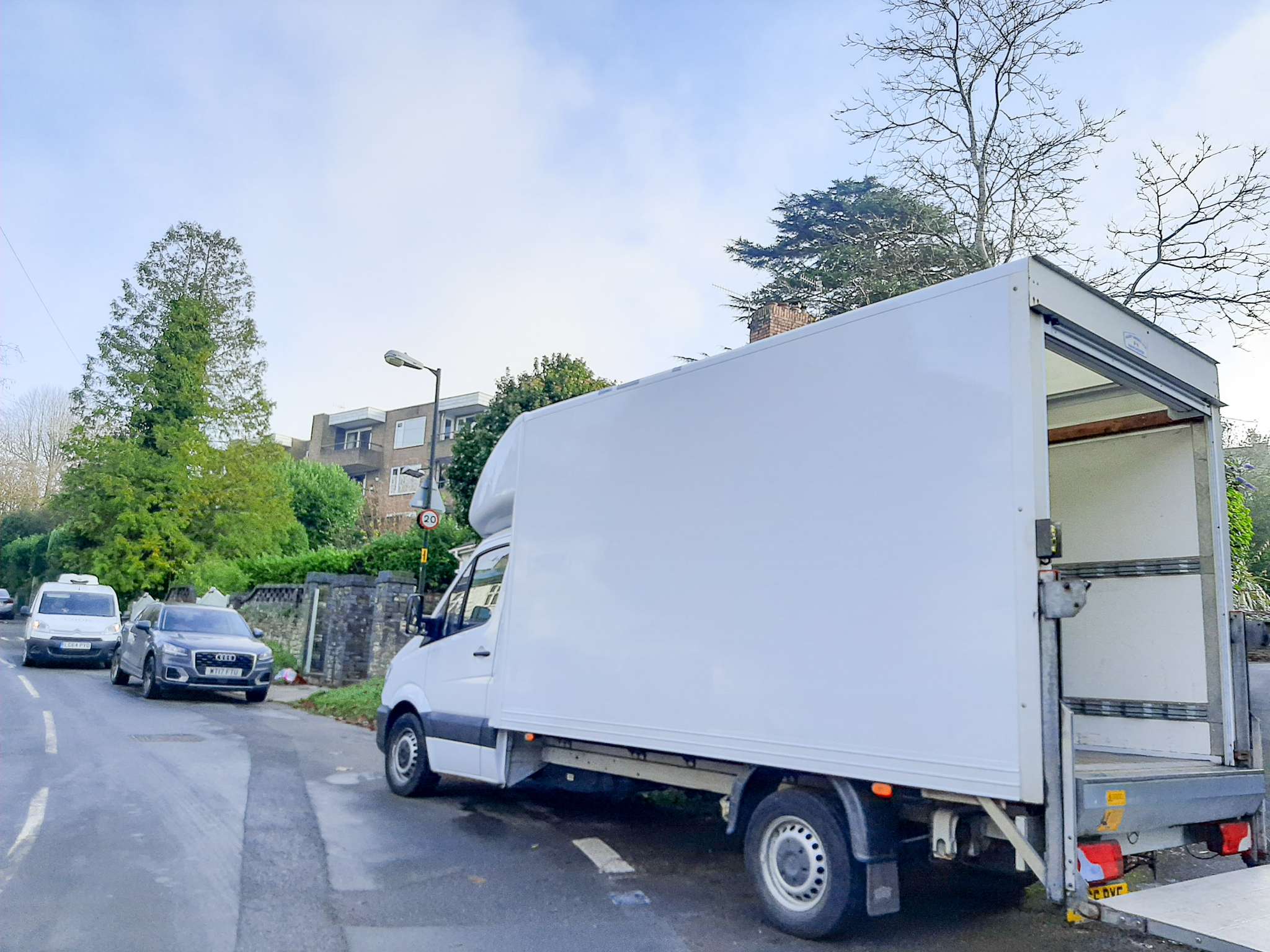 Tree-lined residential street in Stoke Bishop with detached houses and wide driveways