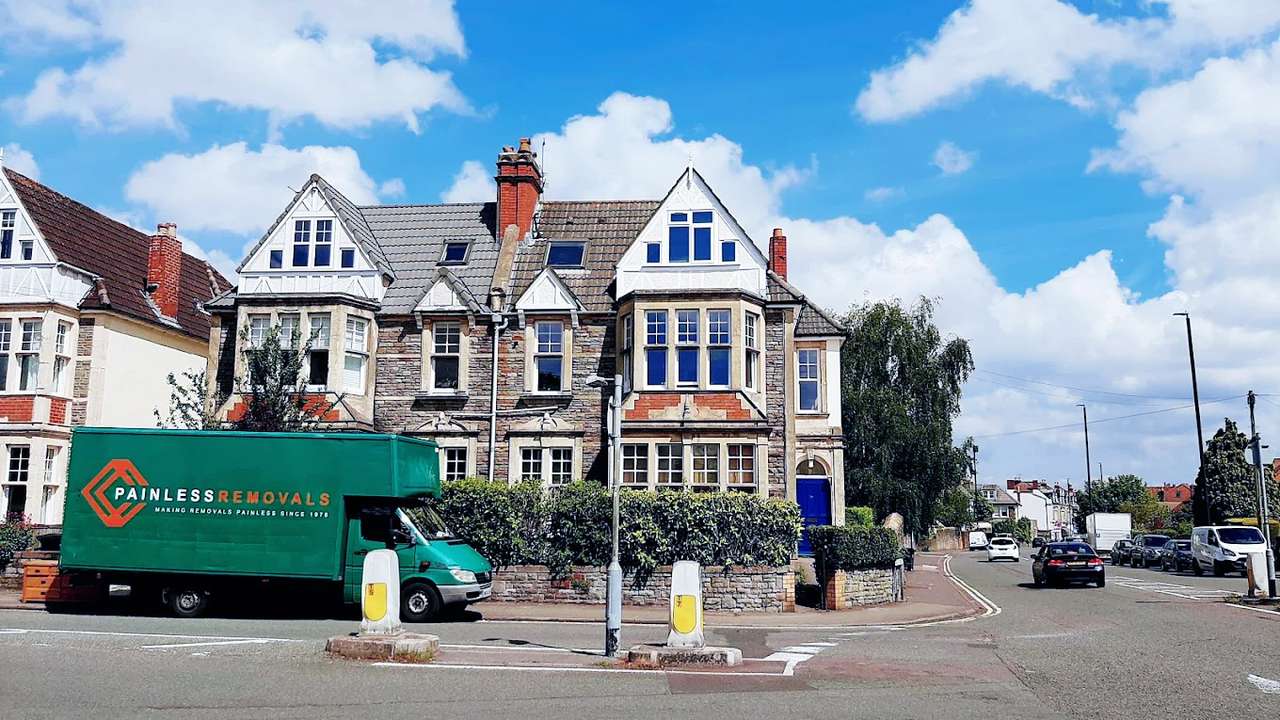 Painless Removals branded van parked outside a Victorian house in Bristol
