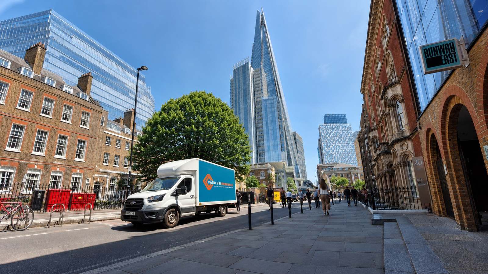 Painless Removals van on a long-distance move in London by the Shard