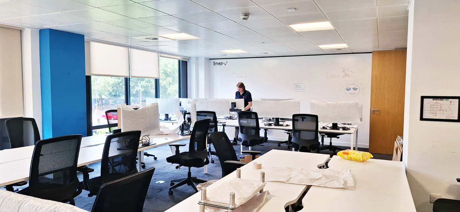 Office set up and ready for occupation — desks assembled and monitors in place after a Painless Removals move