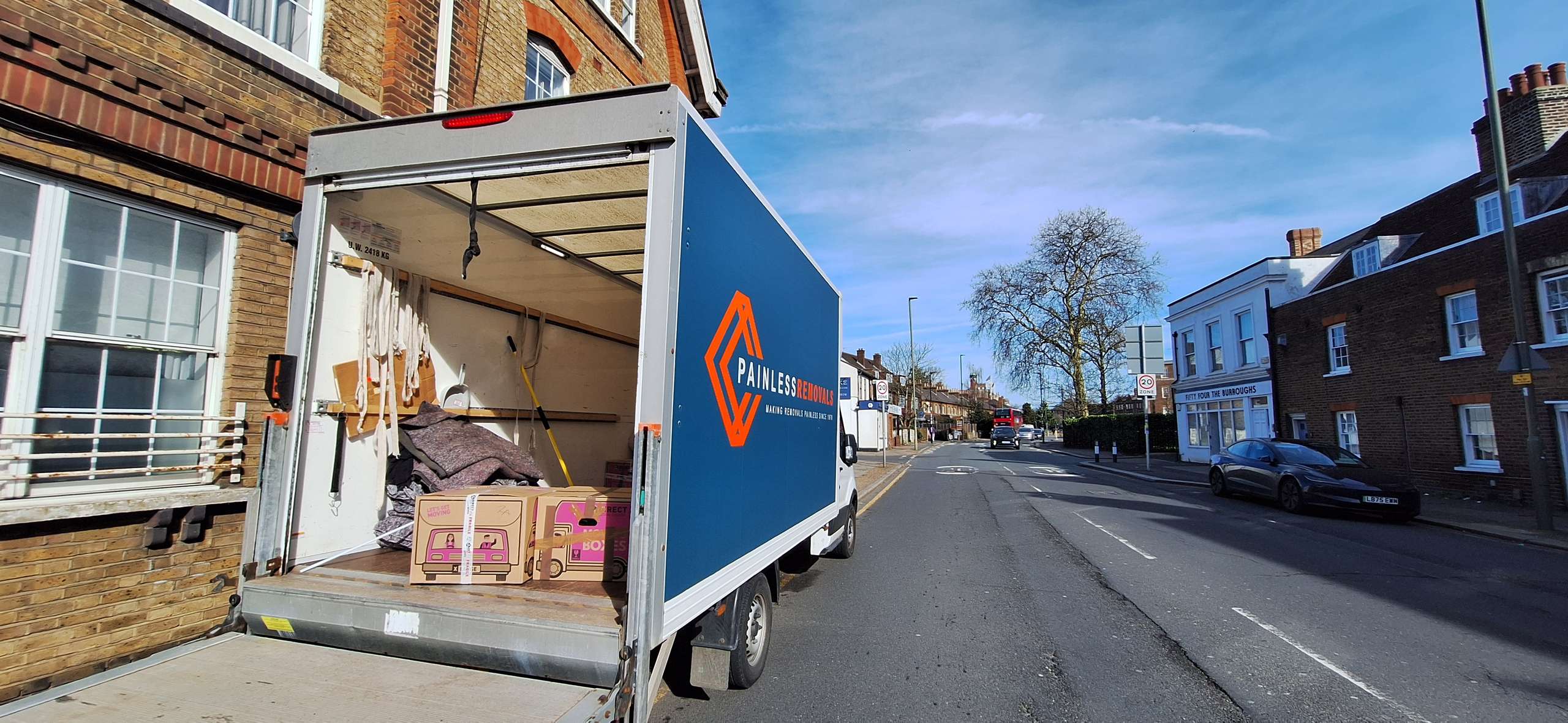 Painless Removals van being loaded for a long-distance move to London